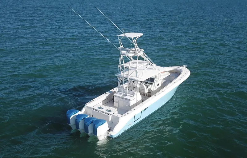 Slide: The Image of 2014 Hydra-Sports 42 boat with triple engines on open water. - 14