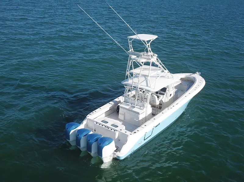 Slide: The Image of 2014 Hydra-Sports 42 boat with triple outboard engines on open water. - 16