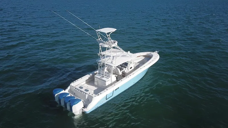 Slide: The Image of 2014 Hydra-Sports 42 boat on open water, featuring triple outboard engines. - 20