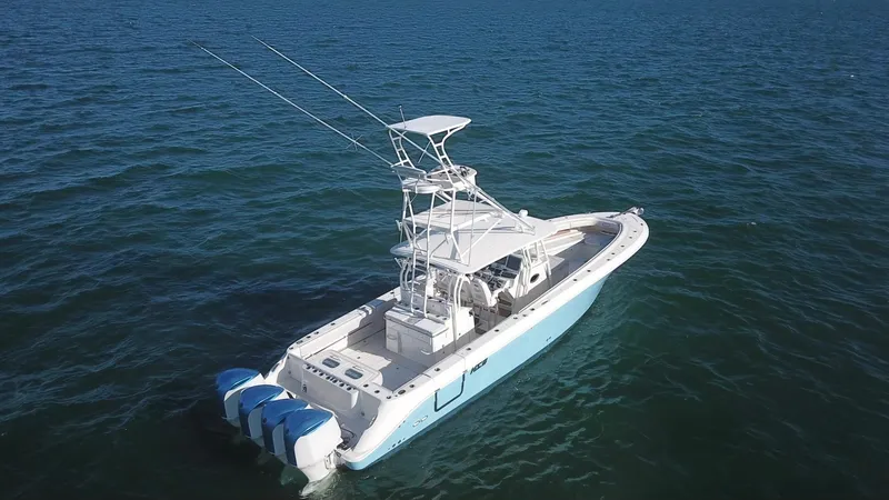 Slide: The Image of 2014 Hydra-Sports 42 boat on open water, featuring triple outboard engines. - 23