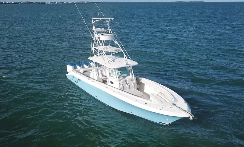 Slide: The Image of 2014 Hydra-Sports 42 boat on open water, featuring a sleek design and multiple engines. - 25