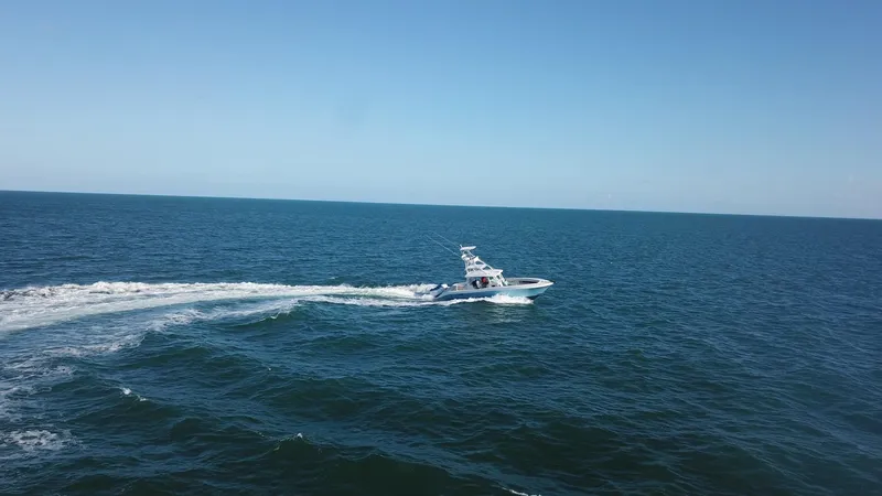 Slide: The Image of 2014 Hydra-Sports 42 boat cruising on open ocean under clear blue sky. - 31