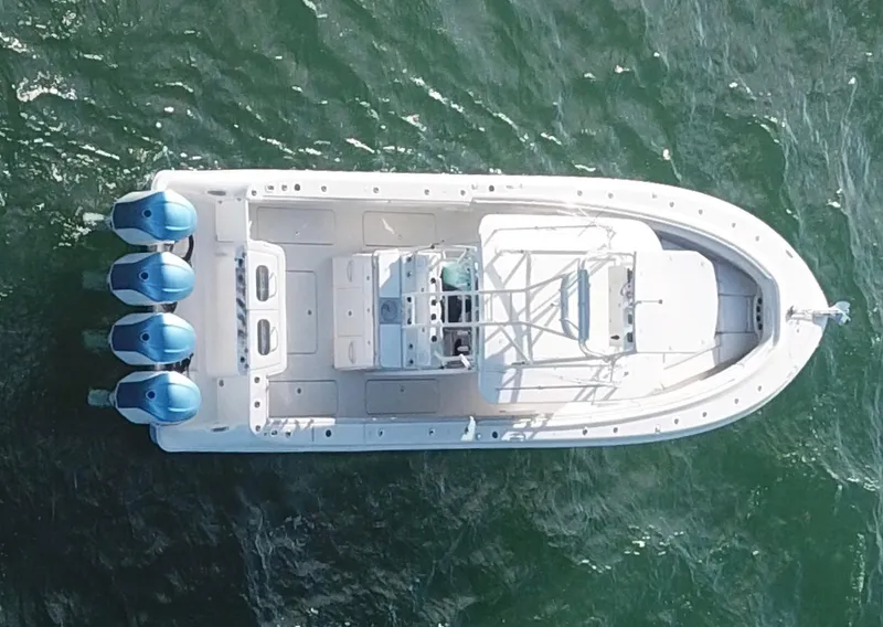 Slide: The Image of Aerial view of 2014 Hydra-Sports 42 boat on water with four engines. - 34