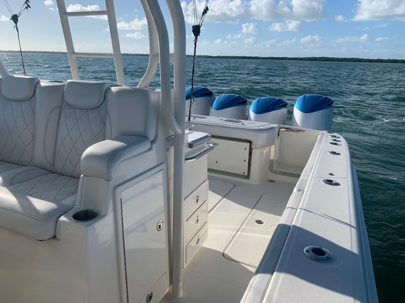 Slide: The Image of 2014 Hydra-Sports 42 boat interior with luxurious seating and multiple engines on open water. - 46