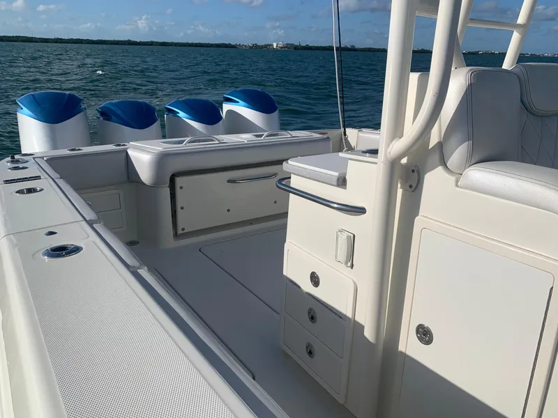 Slide: The Image of 2014 Hydra-Sports 42 boat interior with seating and storage, on a sunny day at sea. - 48