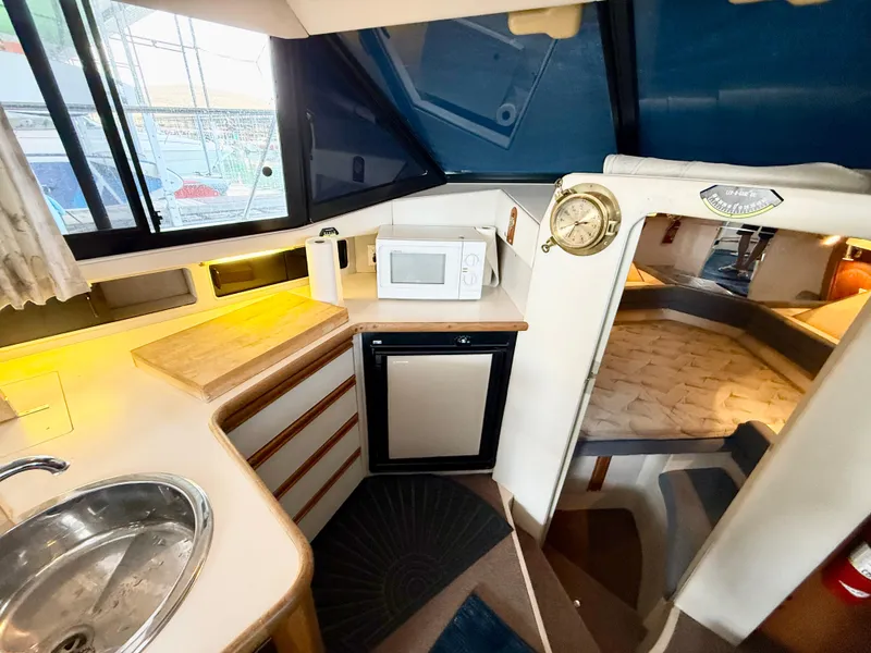 Slide: The Image of Interior of 1992 Carver Command Bridge 2828 with kitchenette and sleeping area. - 10