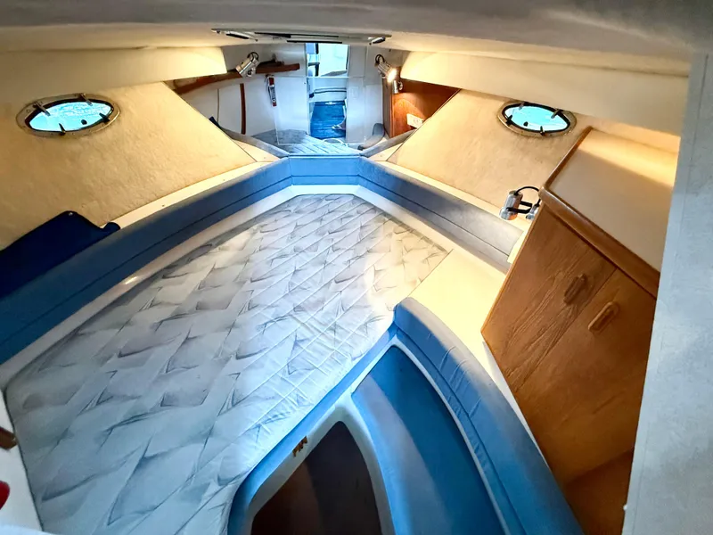 Slide: The Image of Interior of 1992 Carver Command Bridge 2828 with spacious sleeping area and wooden cabinetry. - 11