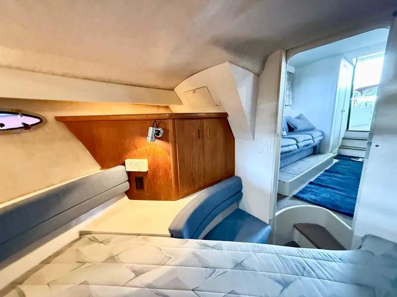 Slide: The Image of Interior of 1992 Carver Command Bridge 2828, featuring cozy seating and wooden cabinetry. - 13