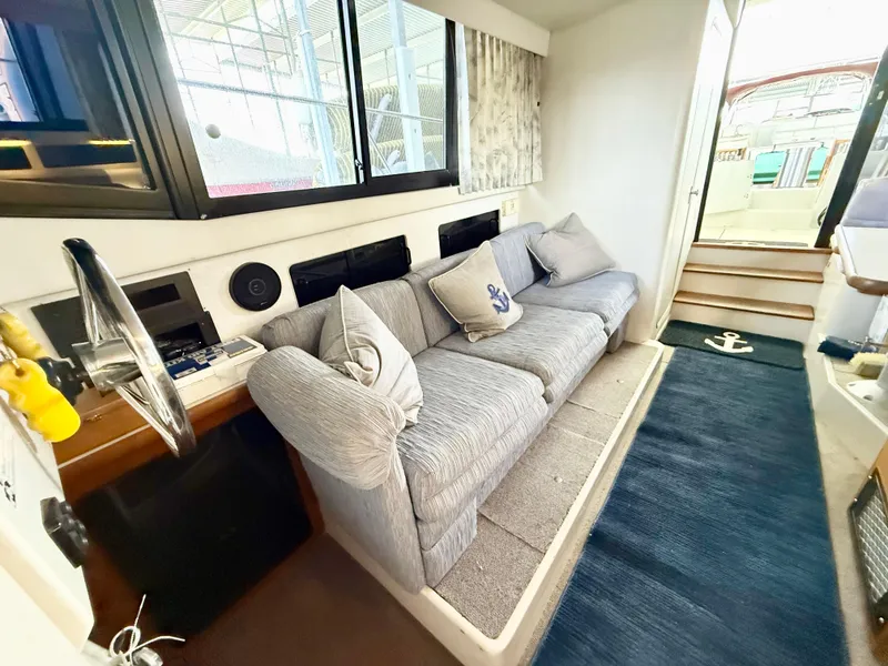 Slide: The Image of Interior of 1992 Carver Command Bridge 2828 with cozy seating and nautical decor. - 14