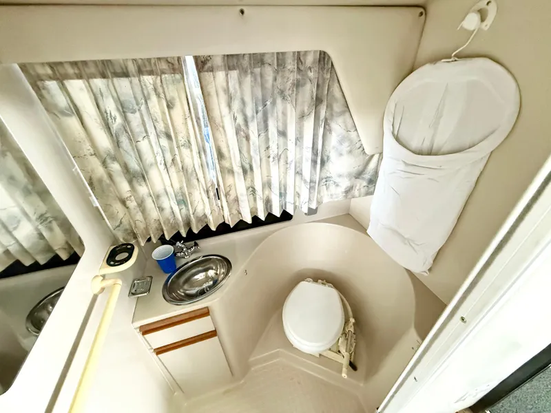 Slide: The Image of 1992 Carver Command Bridge 2828 bathroom with sink, toilet, and window curtains. - 16