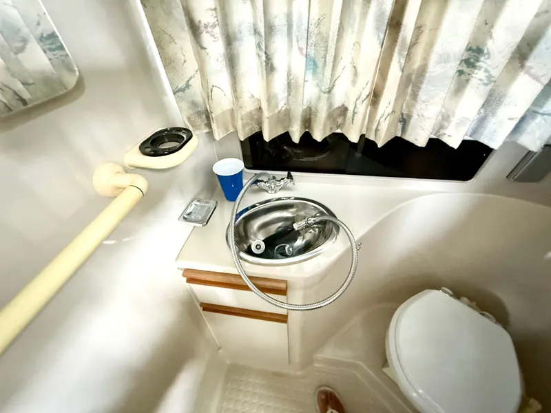Slide: The Image of Bathroom interior of 1992 Carver Command Bridge 2828 with sink and toilet. - 17