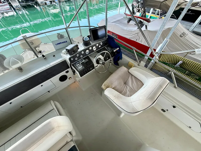 Slide: The Image of 1992 Carver Command Bridge 2828 boat interior with steering wheel and seating. - 20