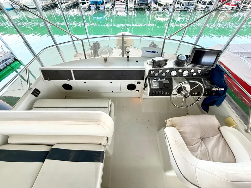 Slide: The Image of 1992 Carver Command Bridge 2828 helm with steering wheel, navigation equipment, and seating. - 21