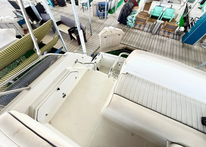 Slide: The Image of 1992 Carver Command Bridge 2828 interior with white seating and dock view. - 22