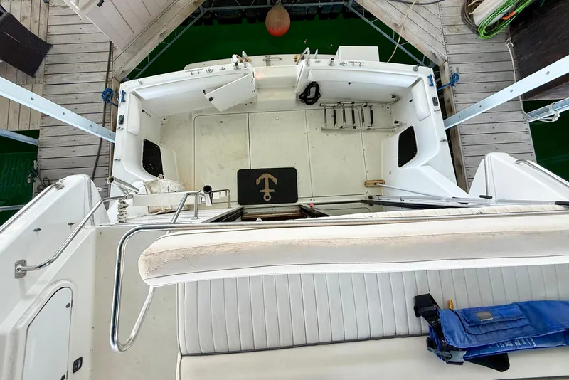 Slide: The Image of 1992 Carver Command Bridge 2828 boat interior, featuring seating and deck area. - 23