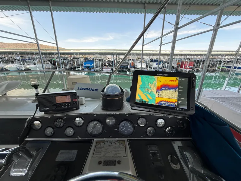 Slide: The Image of 1992 Carver Command Bridge 2828 helm with navigation equipment and marina view. - 24