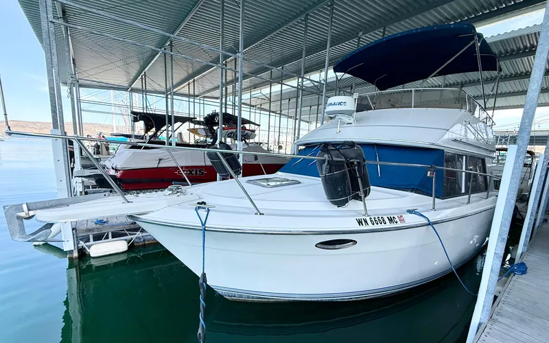 Slide: The Image of 1992 Carver Command Bridge 2828 docked in a marina under a metal canopy. - 5