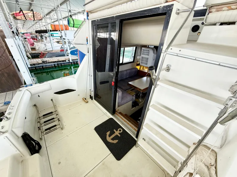 Slide: The Image of 1992 Carver Command Bridge 2828 boat interior with seating area and nautical decor. - 6