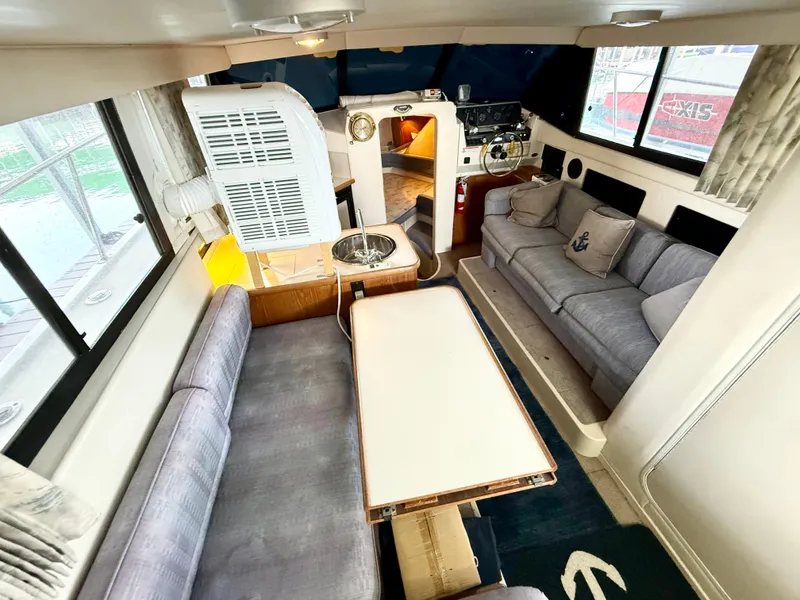 Slide: The Image of Interior of 1992 Carver Command Bridge 2828, featuring seating and helm area. - 8