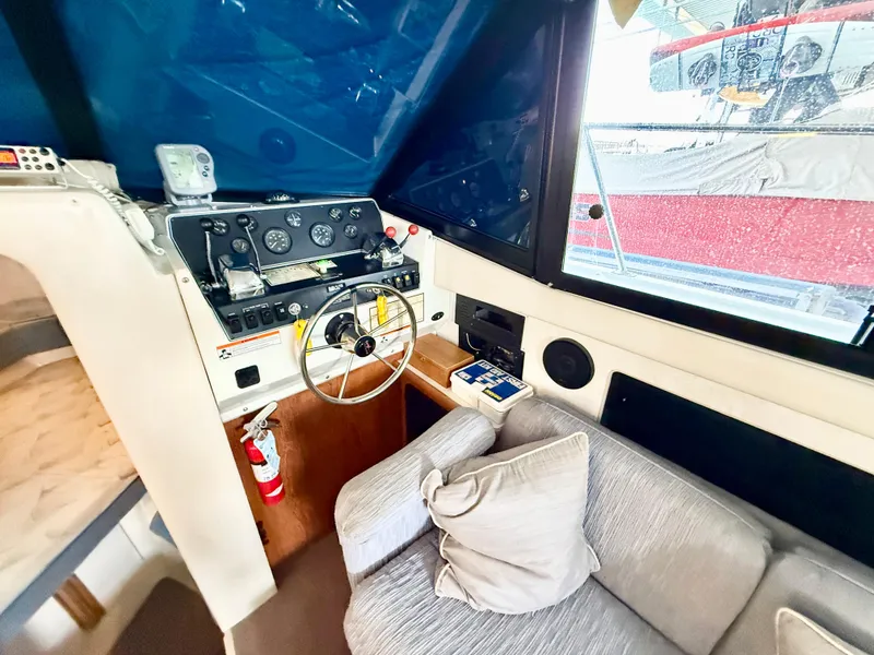 Slide: The Image of Interior of 1992 Carver Command Bridge 2828, featuring helm and seating area. - 9