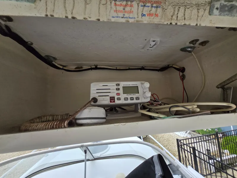 Slide: The Image of 1999 Mako 253 Walk Around boat radio equipment in storage compartment. - 23