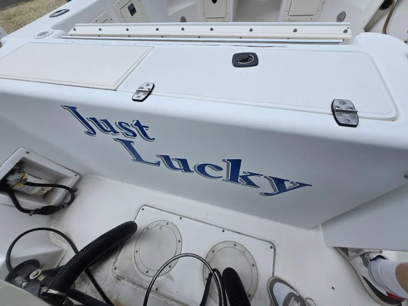 Slide: The Image of 1999 Mako 253 Walk Around boat with "Just Lucky" name on the side. - 29