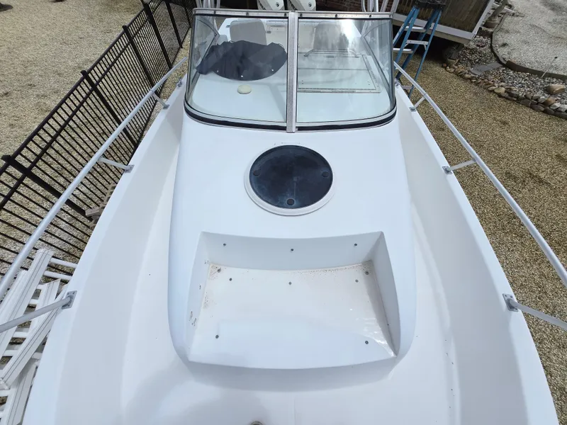 Slide: The Image of 1999 Mako 253 Walk Around boat deck with windshield and hatch. - 9