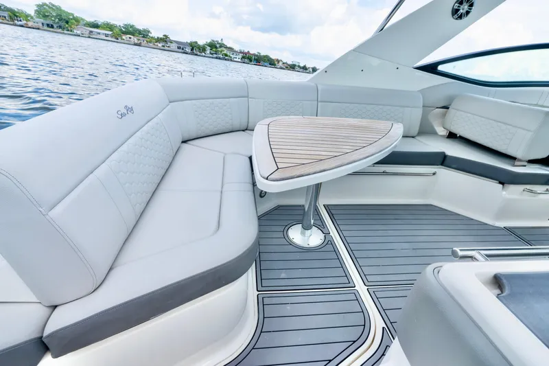 Slide: The Image of Luxurious seating area on 2020 Sea Ray Sundancer 320 boat with elegant table and waterfront view. - 14
