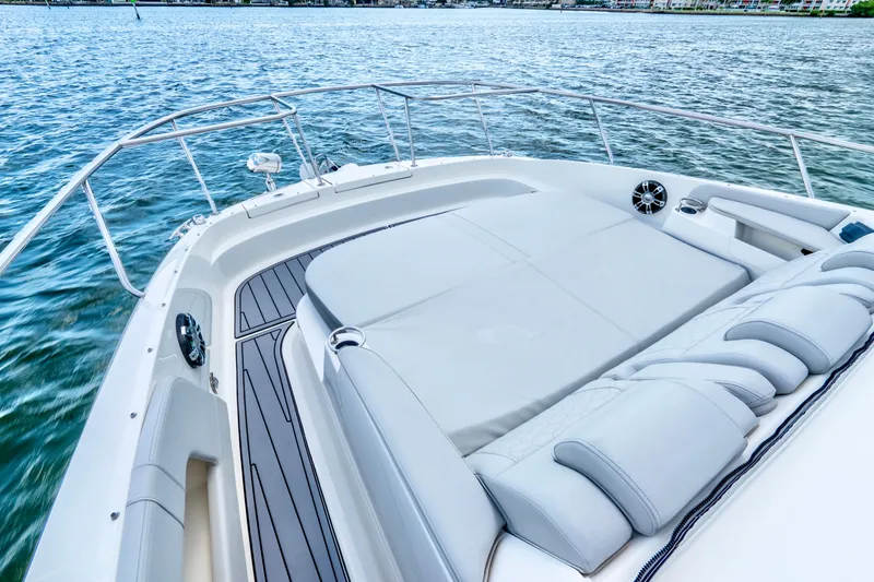 Slide: The Image of 2020 Sea Ray Sundancer 320 boat with spacious deck and luxurious seating on water. - 19