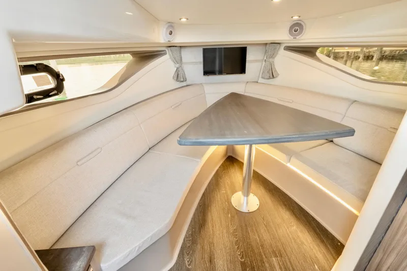 Slide: The Image of 2020 Sea Ray Sundancer 320 interior with elegant seating and modern table design. - 20
