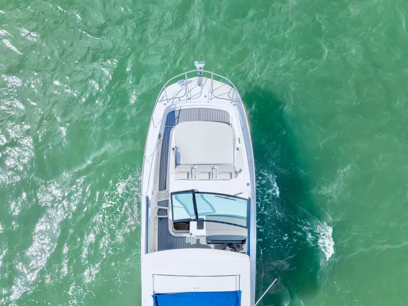 Slide: The Image of Top view of 2020 Sea Ray Sundancer 320 cruising on turquoise water. - 9
