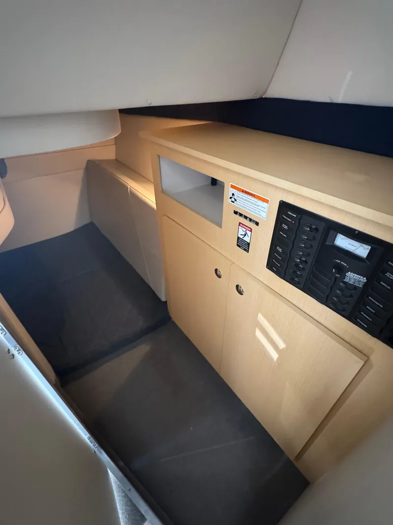 Slide: The Image of Interior cabin of 2011 Bayliner 285 Cruiser with control panel and storage cabinets. - 13