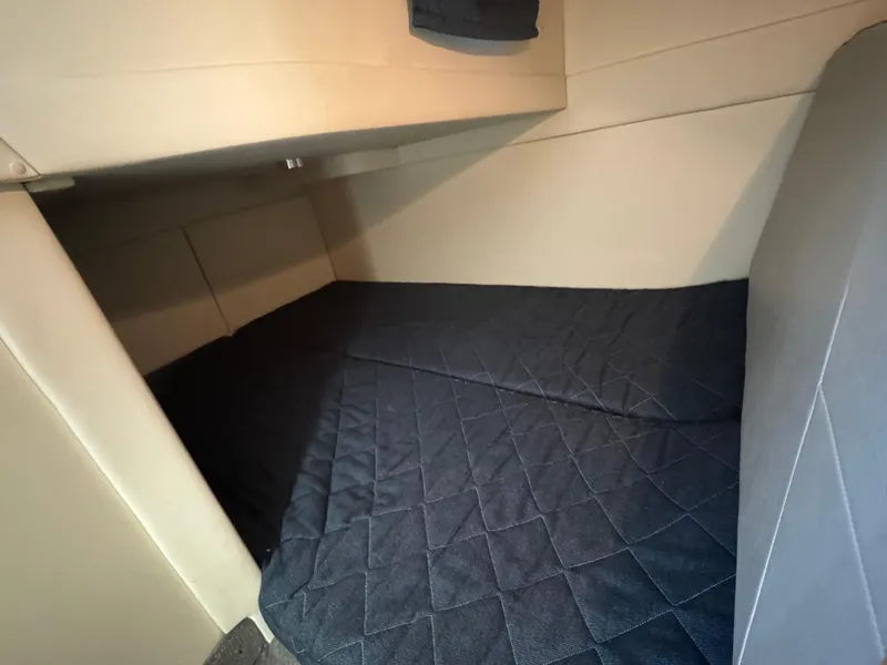 Slide: The Image of Interior cabin of 2011 Bayliner 285 Cruiser with quilted bedding. - 15