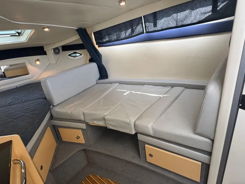 Slide: The Image of Interior of 2011 Bayliner 285 Cruiser with seating and storage compartments. - 9