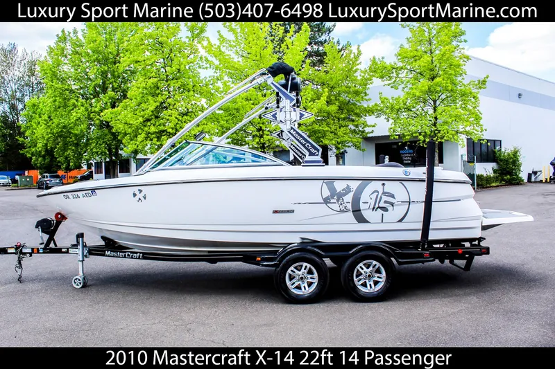 Slide: The Image of 2010 MasterCraft X-15 boat on trailer, 22ft, 14-passenger capacity, displayed outdoors. - 0