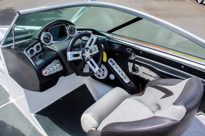 Slide: The Image of 2010 MasterCraft X-15 boat interior with steering wheel and dashboard controls. - 10