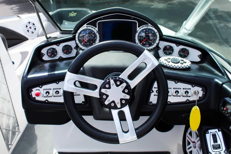 Slide: The Image of Steering wheel and dashboard of a 2010 MasterCraft X-15 boat. - 11
