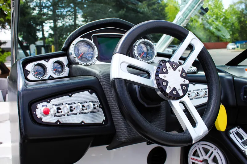 Slide: The Image of 2010 MasterCraft X-15 boat dashboard with steering wheel and gauges. - 12