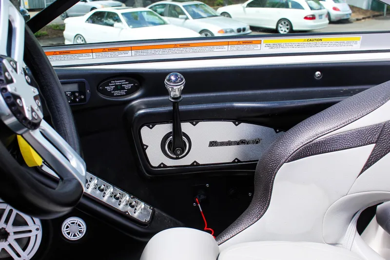 Slide: The Image of Interior of a 2010 MasterCraft X-15 boat with steering wheel and control panel. - 14