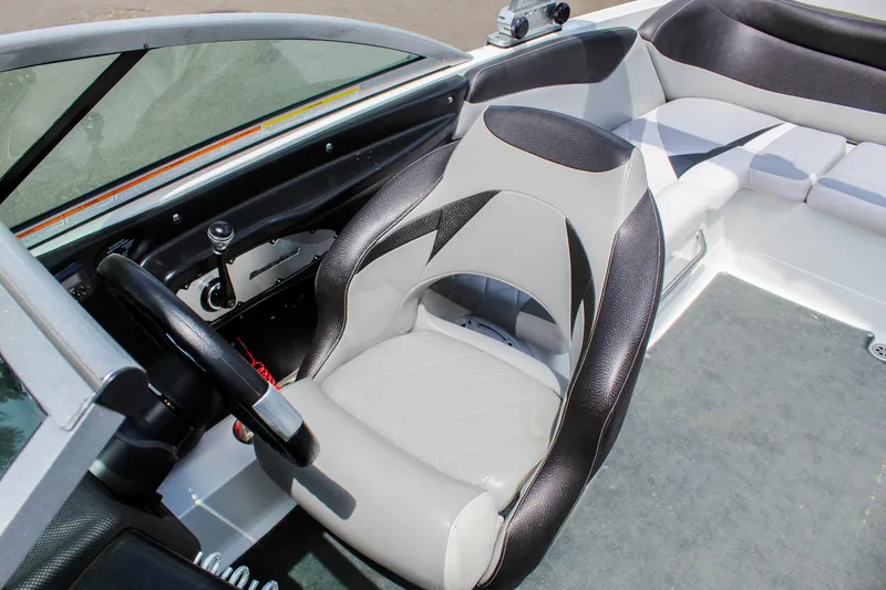 Slide: The Image of 2010 MasterCraft X-15 boat interior with sleek seating and steering wheel. - 15