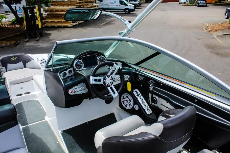 Slide: The Image of 2010 MasterCraft X-15 boat interior with modern dashboard and steering wheel. - 16