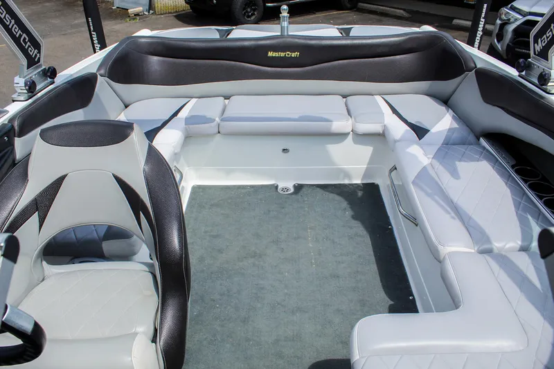 Slide: The Image of 2010 MasterCraft X-15 boat interior with gray and black seating, spacious layout. - 24