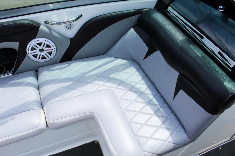 Slide: The Image of 2010 MasterCraft X-15 boat interior with white quilted seats and speaker detail. - 25