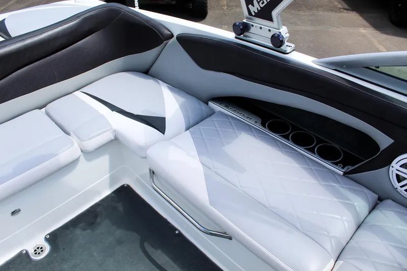 Slide: The Image of 2010 MasterCraft X-15 boat interior with white and black seating and cup holders. - 26