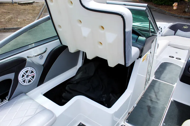 Slide: The Image of 2010 MasterCraft X-15 boat interior with open storage compartment and speaker. - 32