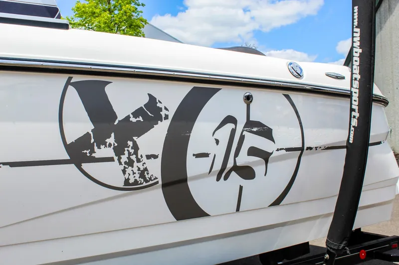 Slide: The Image of 2010 MasterCraft X-15 boat with distinctive side graphics under a blue sky. - 35