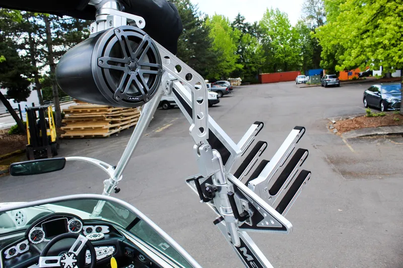 Slide: The Image of 2010 MasterCraft X-15 boat with wakeboard rack and speaker in a parking lot. - 37