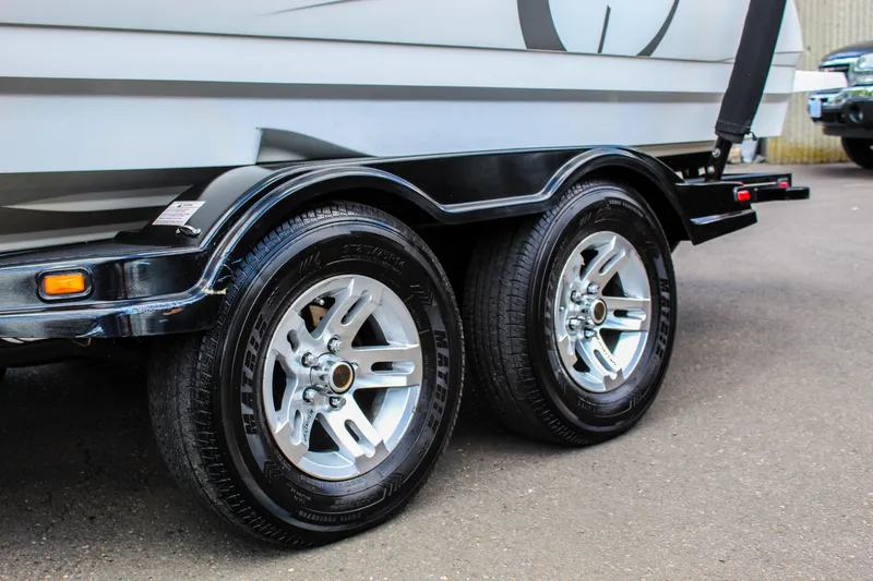 Slide: The Image of Trailer wheels of a 2010 MasterCraft X-15 boat on pavement. - 39