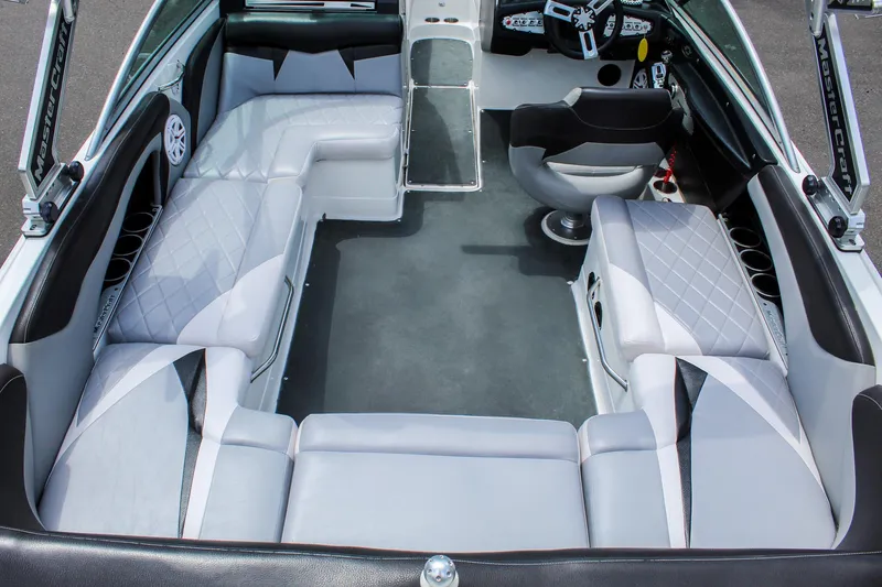Slide: The Image of Interior of a 2010 MasterCraft X-15 boat with spacious seating and modern design. - 8