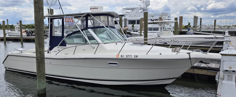 Slide: The Image of 2001 Pursuit 2860 Denali boat docked at marina, for sale sign visible. - 0